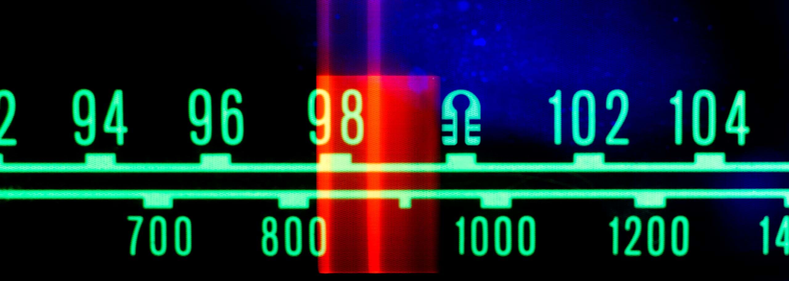 Picture closeup Hindenburg Radio FM Meter with a lifejacket as a digit to illustrate how Long Form Radio can Save Us All