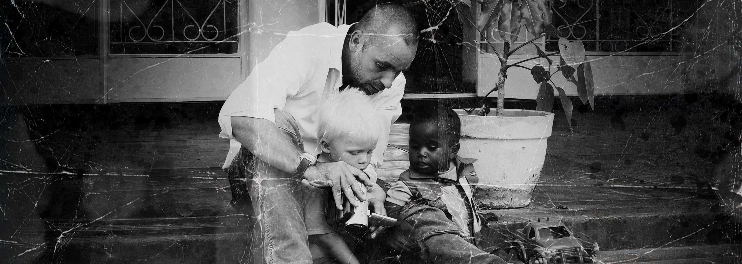 Nick Dunkerley, founder of Hindenburg Systems, sitting with his son and a friend on the veranda of his home in Zambia where the idea for Hindenburg began