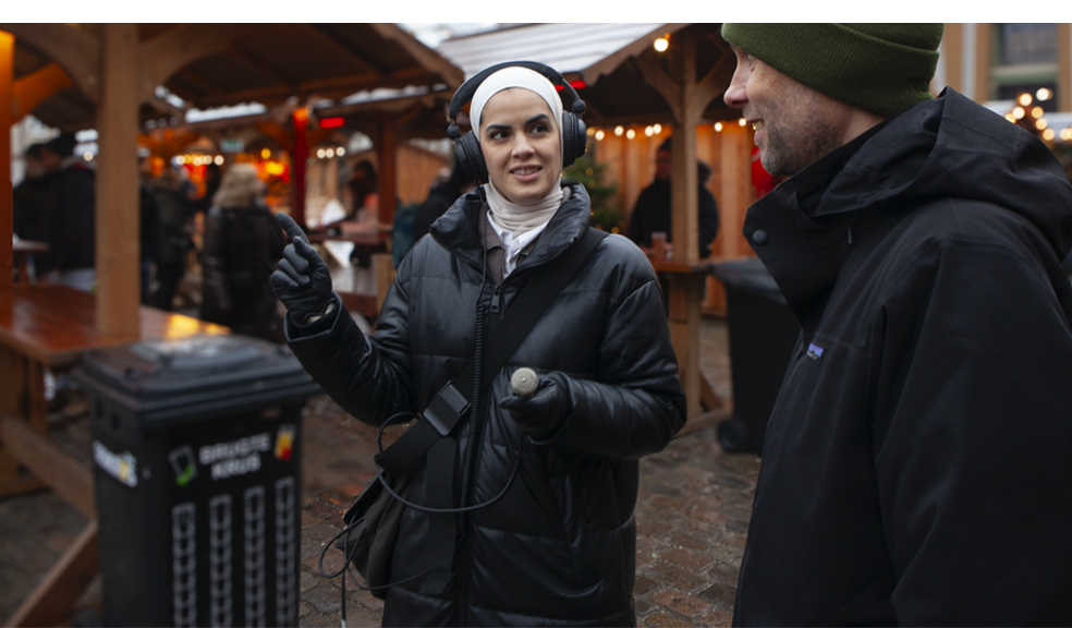 Hindenburg Systems Female Journalist with headphones and Electro Voice 635 Microphone Directing an Interview