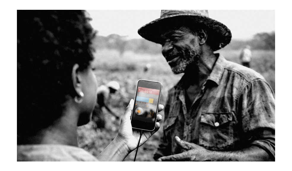 Community journalist in Zambia recording an interview with a local farmer using the Hindenburg Field Recorder app